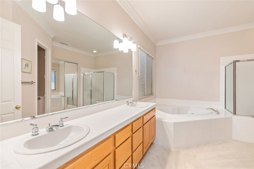 29546 Winding Brook Drive Menifee, CA 92584 - Photo 13 of 21 a bathroom with a tub sink and mirror