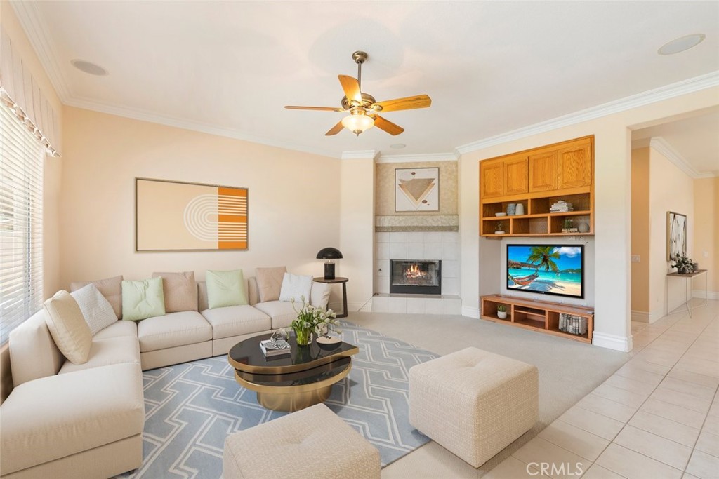 29546 Winding Brook Drive Menifee, CA 92584 - Photo 5 of 21 a living room with furniture a fireplace and a window