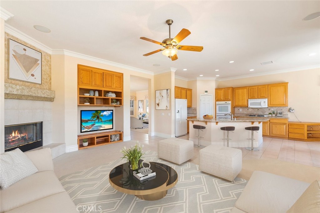29546 Winding Brook Drive Menifee, CA 92584 - Photo 6 of 21 a living room with furniture kitchen view and a fireplace