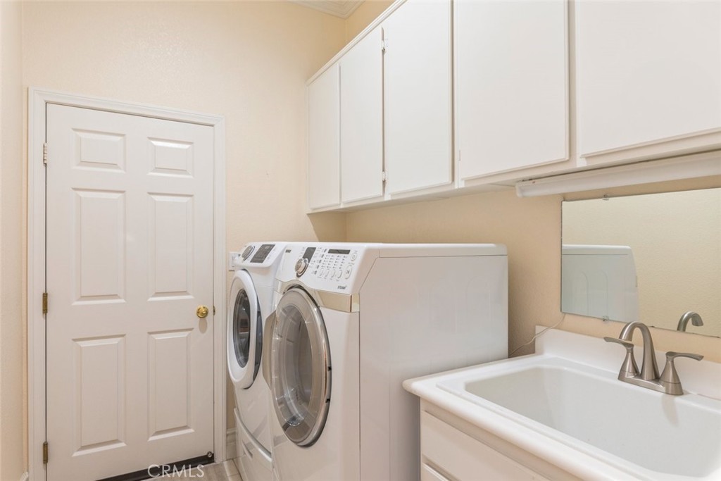 29546 Winding Brook Drive Menifee, CA 92584 - Photo 9 of 21 a utility room with dryer and washer