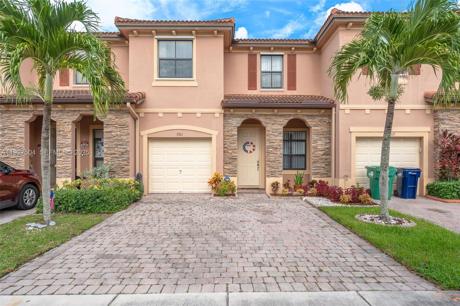 a front view of a house with garden