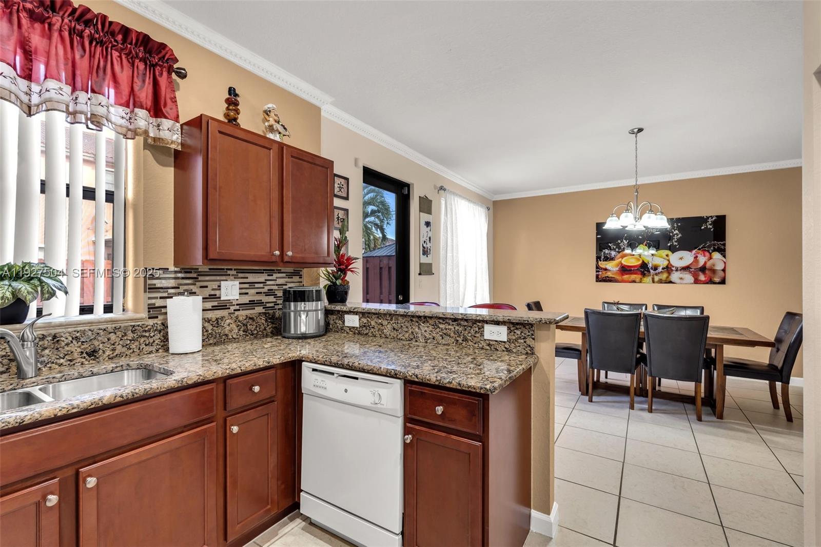 7161 Southwest 163rd Place Miami, FL 33193 - Photo 12 of 39 a kitchen with stainless steel appliances granite countertop a sink and a refrigerator