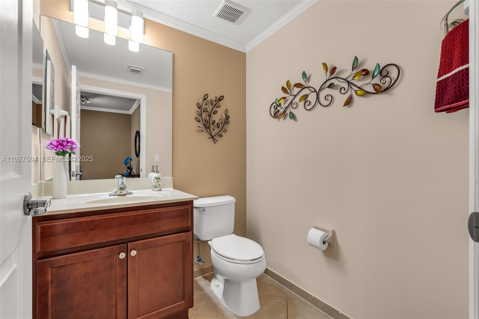 7161 Southwest 163rd Place Miami, FL 33193 - Photo 13 of 39 a bathroom with a sink mirror vanity and toilet