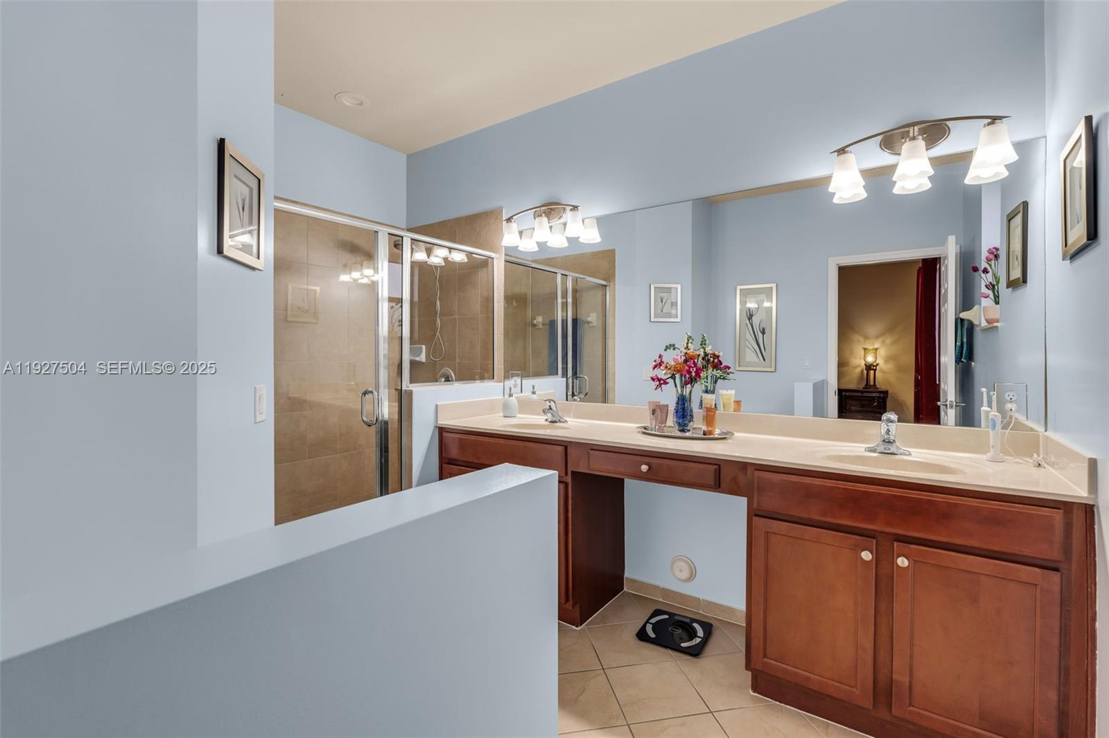 7161 Southwest 163rd Place Miami, FL 33193 - Photo 24 of 39 a spacious bathroom with a granite countertop sink a mirror and a shower