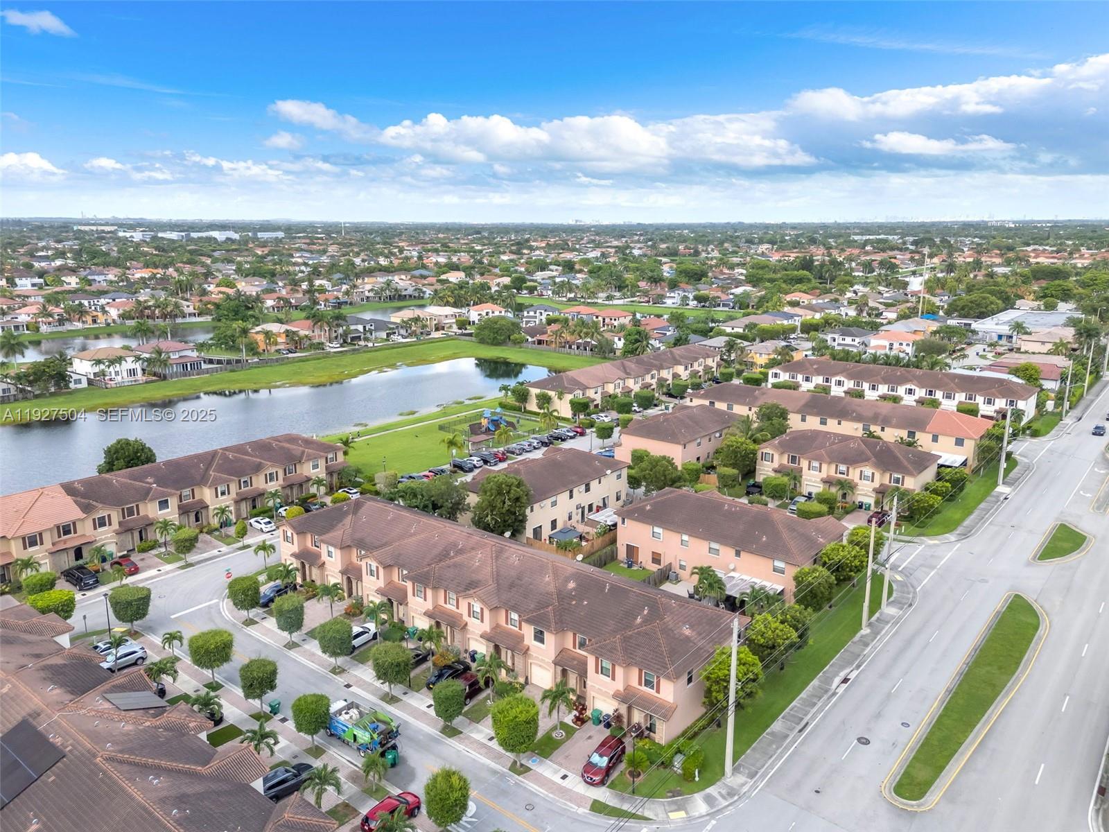 7161 Southwest 163rd Place Miami, FL 33193 - Photo 32 of 39 an aerial view of a city with lots of residential buildings and ocean view in back