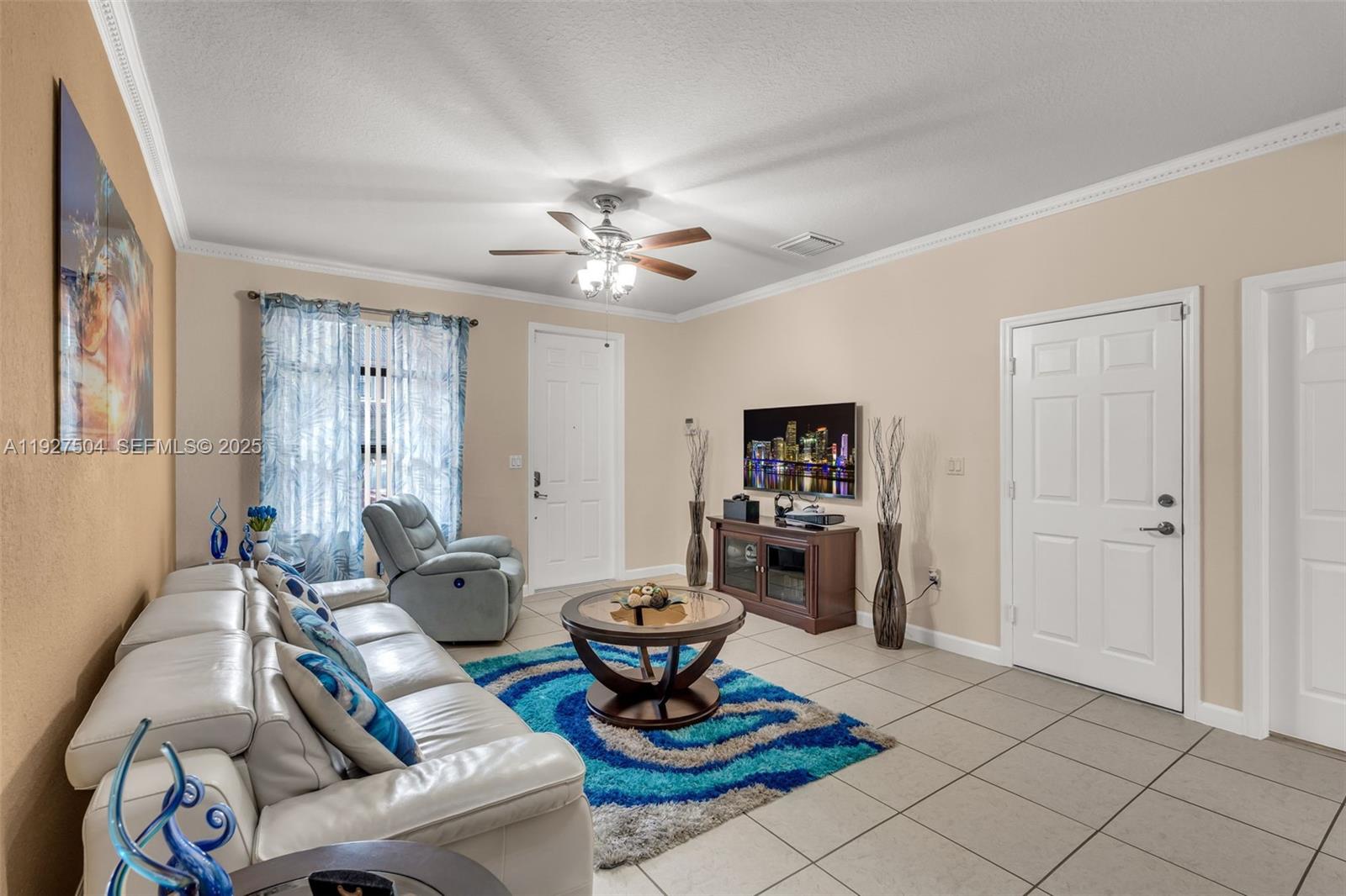7161 Southwest 163rd Place Miami, FL 33193 - Photo 5 of 39 a living room with furniture a flat screen tv and a window