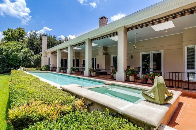 a view of a house with backyard porch and sitting area