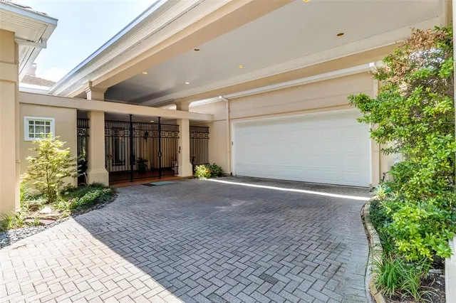 a view of a house with a yard and potted plants