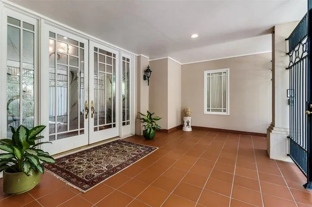 a view of a hallway with wooden floor and a potted plant