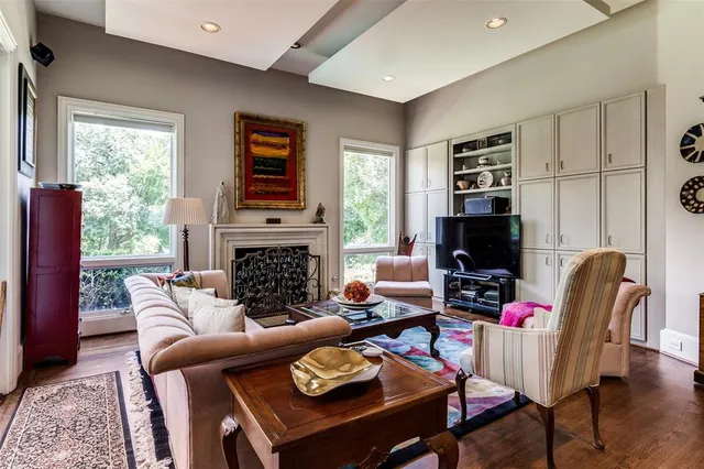 a living room with furniture a fireplace and a flat screen tv