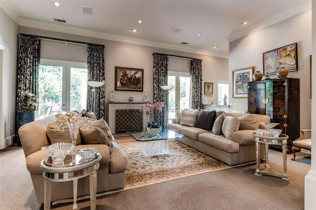 a living room with furniture a fireplace and a large window