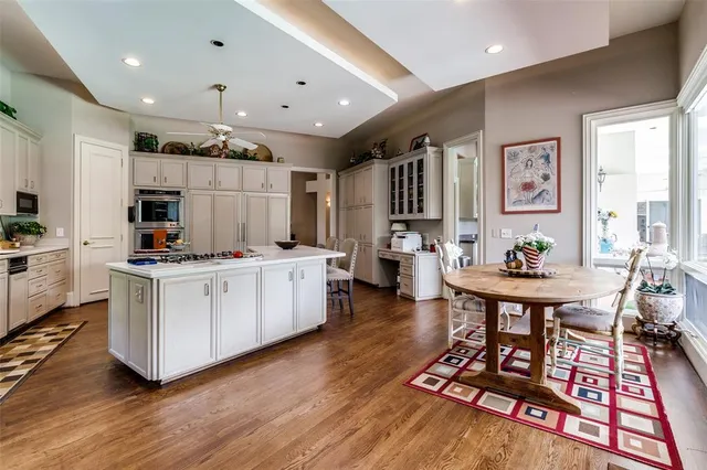 a living room with furniture a table and kitchen view