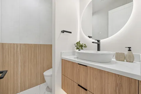 a bathroom with a sink toilet and mirror