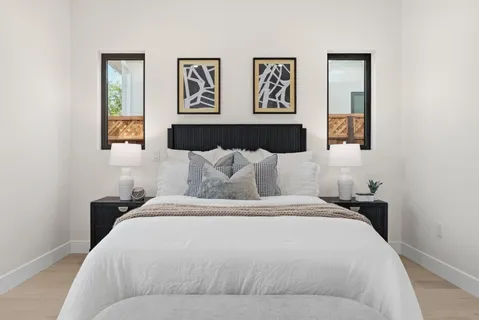 a bedroom with a bed and wall painting