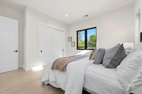 a bedroom with a large bed and a window
