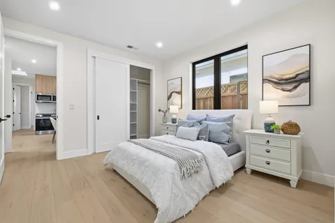 a bedroom with a bed and a painting on the wall