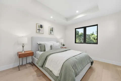 a bedroom with bed and a night stand