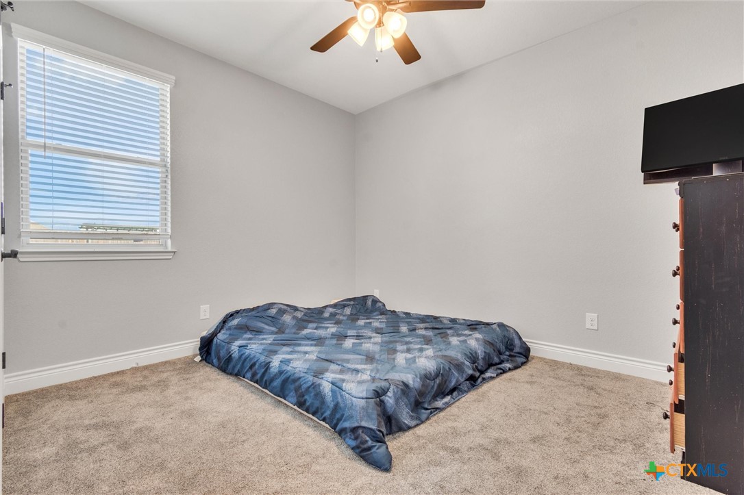 3919 Gracey Lane Kempner, TX 76539 - Photo 28 of 44 a spacious bedroom with a bed and a flat screen tv