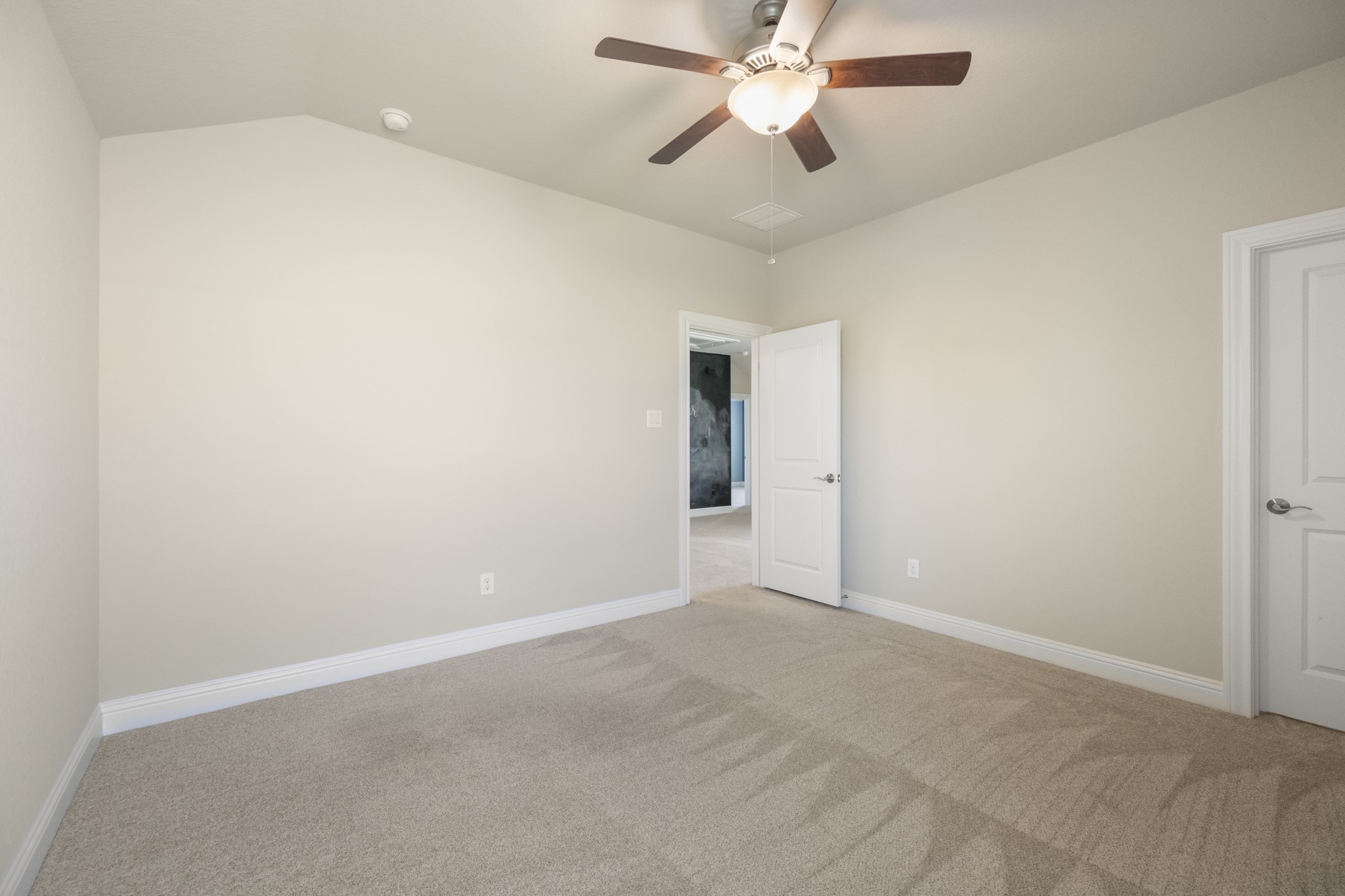 7502 Windsor Park Court Spring, TX 77379 - Photo 37 of 50 an empty room with a chandelier fan and windows