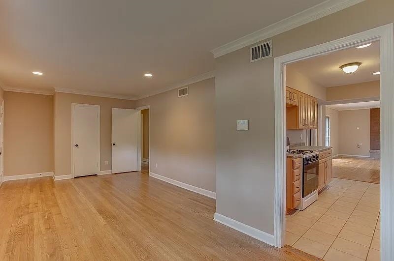 4974 Princeton Road Memphis, TN 38117 - Photo 5 of 10 Spare room featuring ornamental molding, light wood-style flooring, and recessed lighting