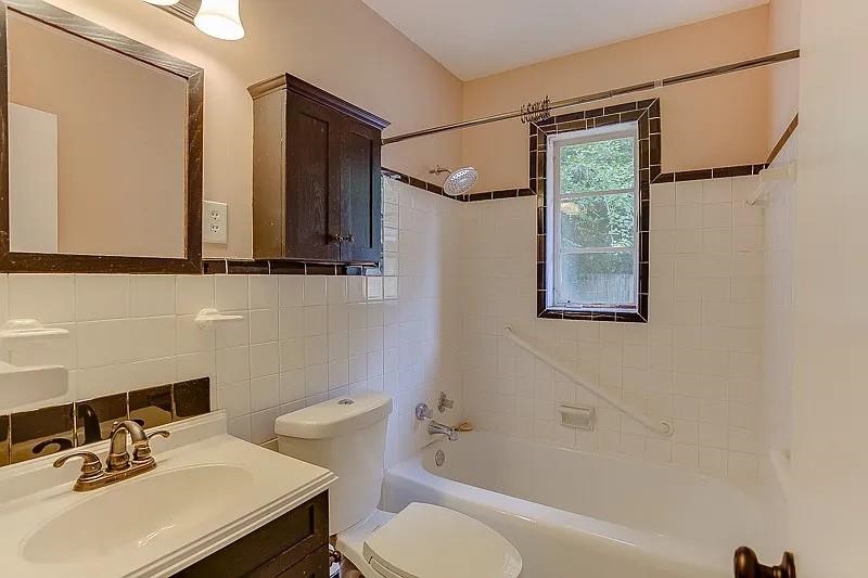 4974 Princeton Road Memphis, TN 38117 - Photo 9 of 10 Full bath with tile walls, vanity, tub / shower combination, and backsplash