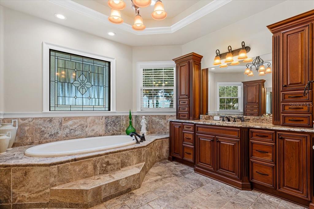 4107 Southwest State Road 45 Newberry, FL 32669 - Photo 14 of 100 a spacious bathroom with a tub double sink and a large mirror
