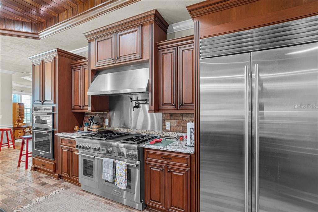 4107 Southwest State Road 45 Newberry, FL 32669 - Photo 27 of 100 a kitchen with stainless steel appliances granite countertop a stove and a refrigerator
