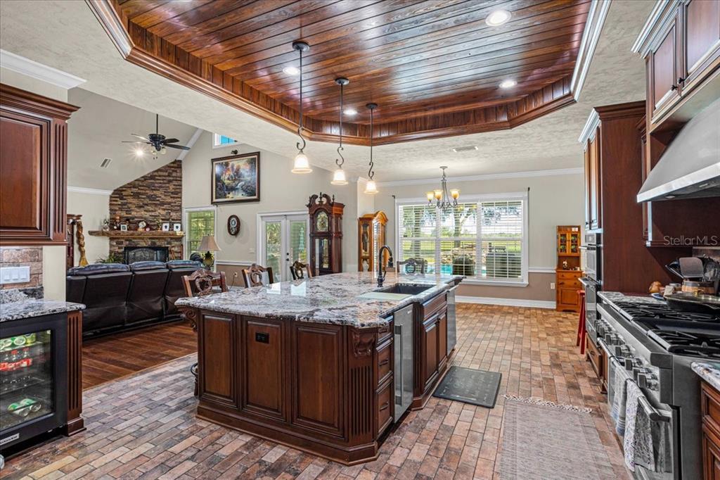 4107 Southwest State Road 45 Newberry, FL 32669 - Photo 28 of 100 a dining hall with stainless steel appliances granite countertop a stove a sink and a refrigerator