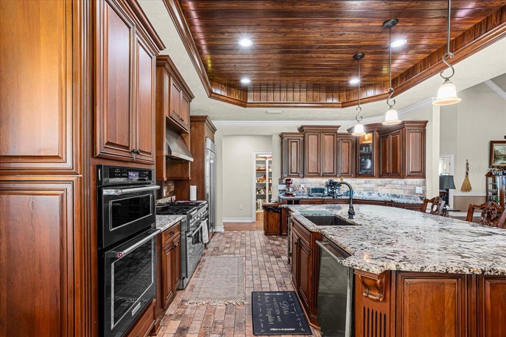 4107 Southwest State Road 45 Newberry, FL 32669 - Photo 30 of 100 a kitchen with stainless steel appliances granite countertop a stove and a sink