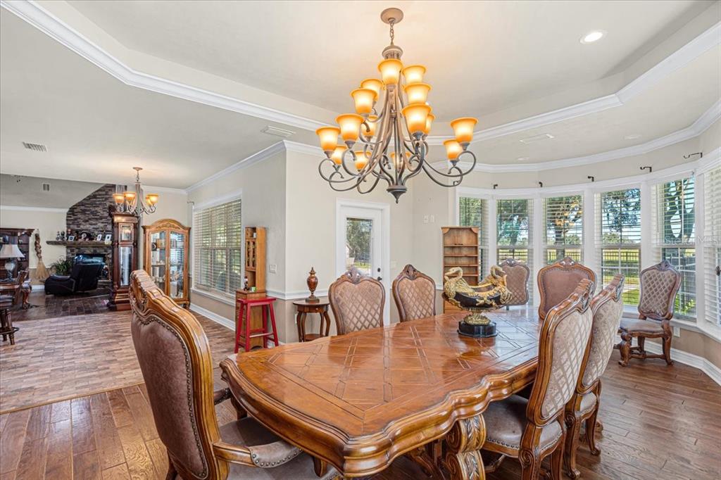 4107 Southwest State Road 45 Newberry, FL 32669 - Photo 33 of 100 a view of a dining room with furniture wooden floor and chandelier