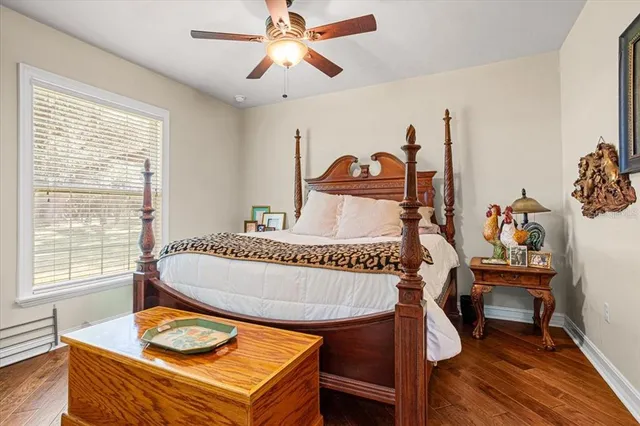 a bedroom with a bed a window and a flat screen tv