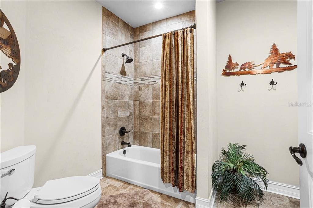 4107 Southwest State Road 45 Newberry, FL 32669 - Photo 41 of 100 a bathroom with a toilet a sink and bathtub