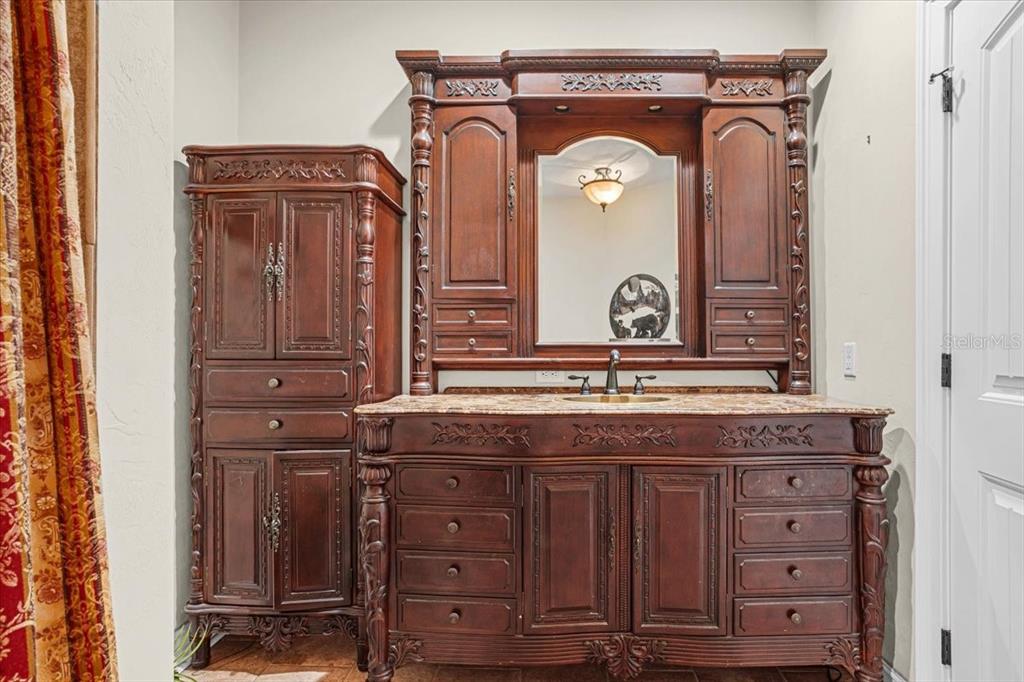 4107 Southwest State Road 45 Newberry, FL 32669 - Photo 42 of 100 a bathroom with a granite countertop sink vanity and a mirror