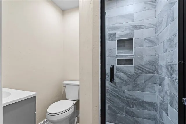 a living room with furniture ceiling fan and a rug