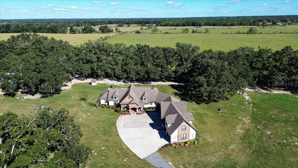 4107 Southwest State Road 45 Newberry, FL 32669 - Photo 69 of 100 an aerial view of a house with a yard and lake view