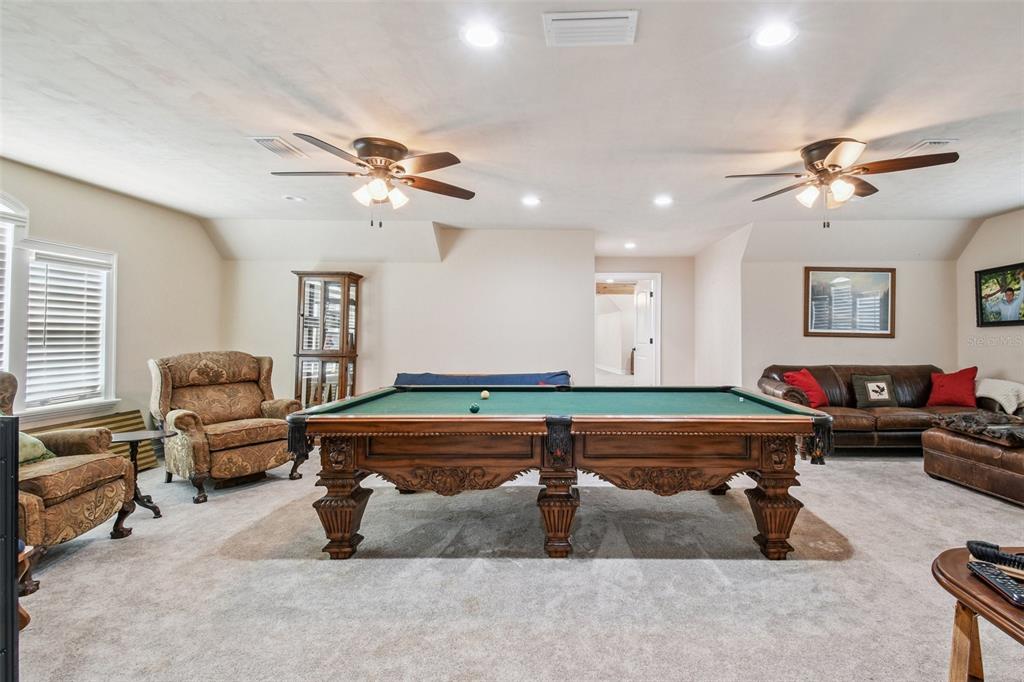 4107 Southwest State Road 45 Newberry, FL 32669 - Photo 82 of 100 a living room with furniture gym equipment and a chandelier