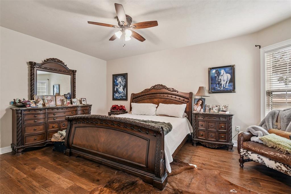 4107 Southwest State Road 45 Newberry, FL 32669 - Photo 86 of 100 a bedroom with a bed and a chandelier