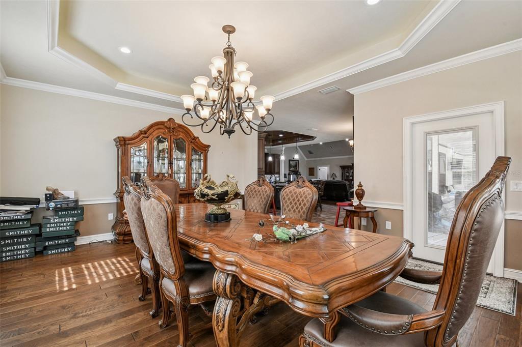 4107 Southwest State Road 45 Newberry, FL 32669 - Photo 92 of 100 a view of a dining room with furniture a chandelier and wooden floor