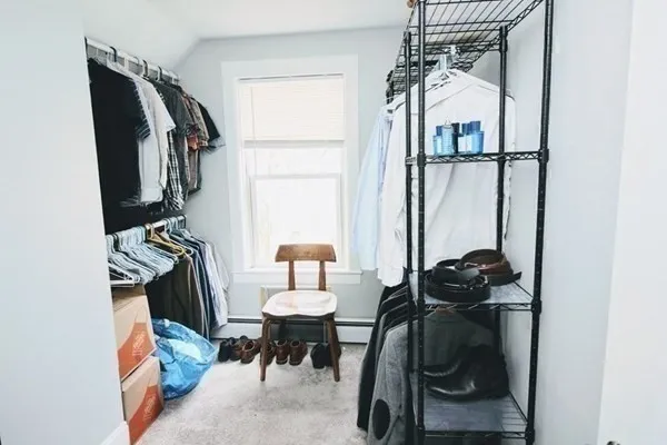 a view of walk in closet with clothes and shoes