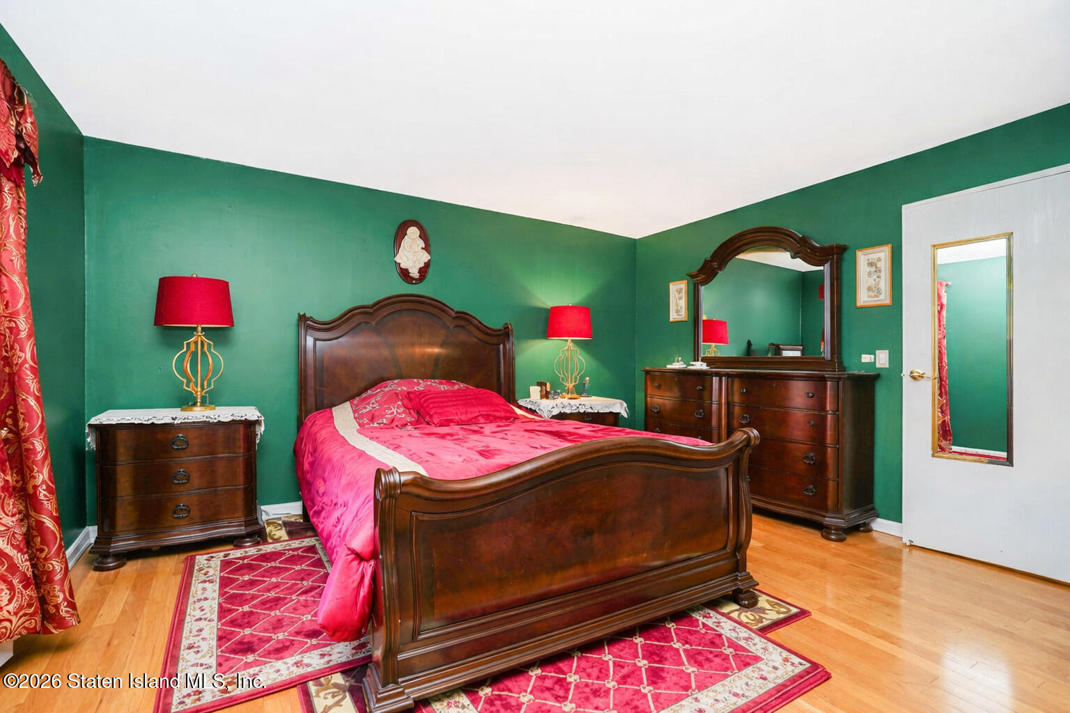 120 Devon Loop, Unit 6 Staten Island, NY 10314 - Photo 14 of 19 a bedroom with a bed and wooden floor