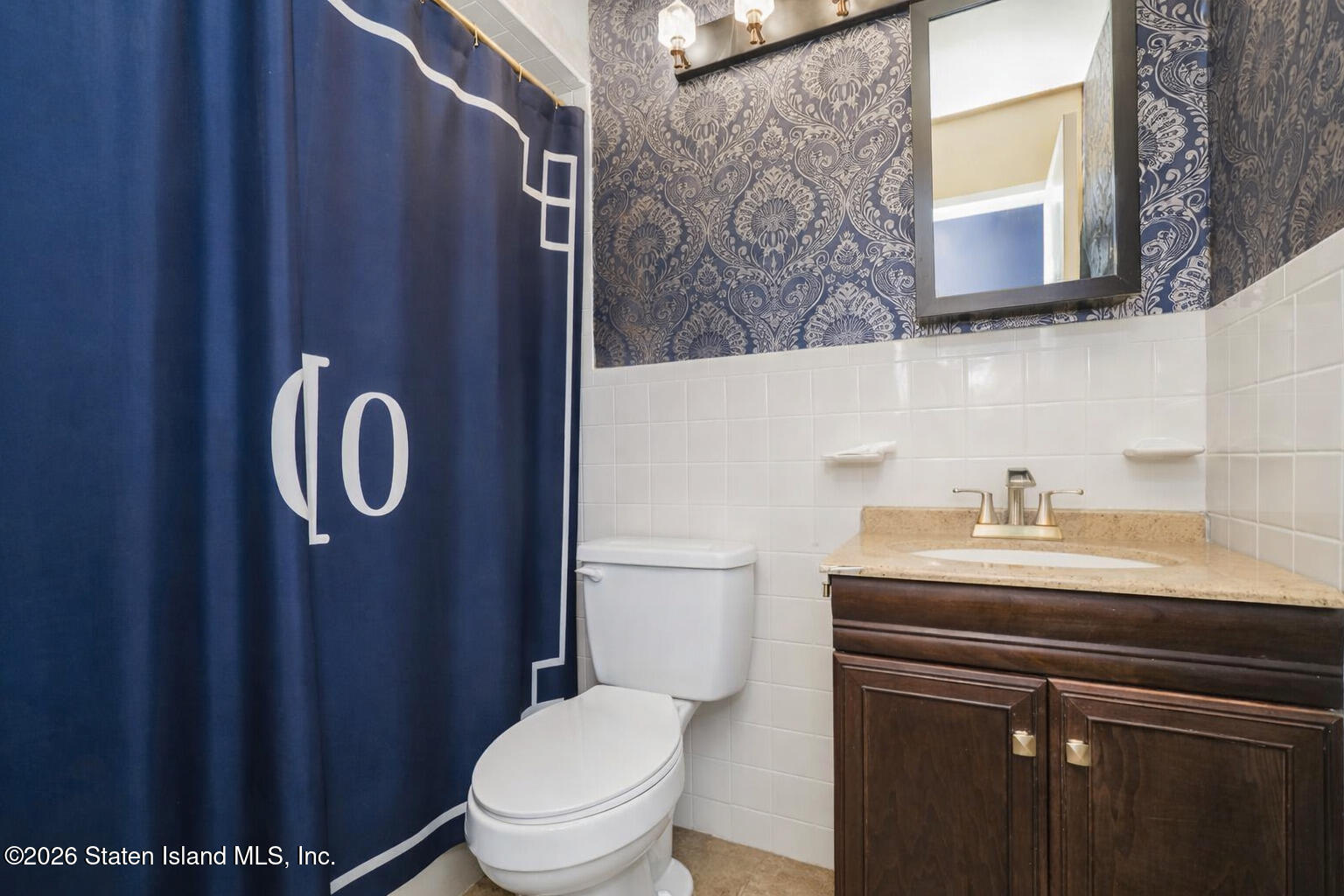 120 Devon Loop, Unit 6 Staten Island, NY 10314 - Photo 16 of 19 a bathroom with a granite countertop toilet sink mirror and vanity