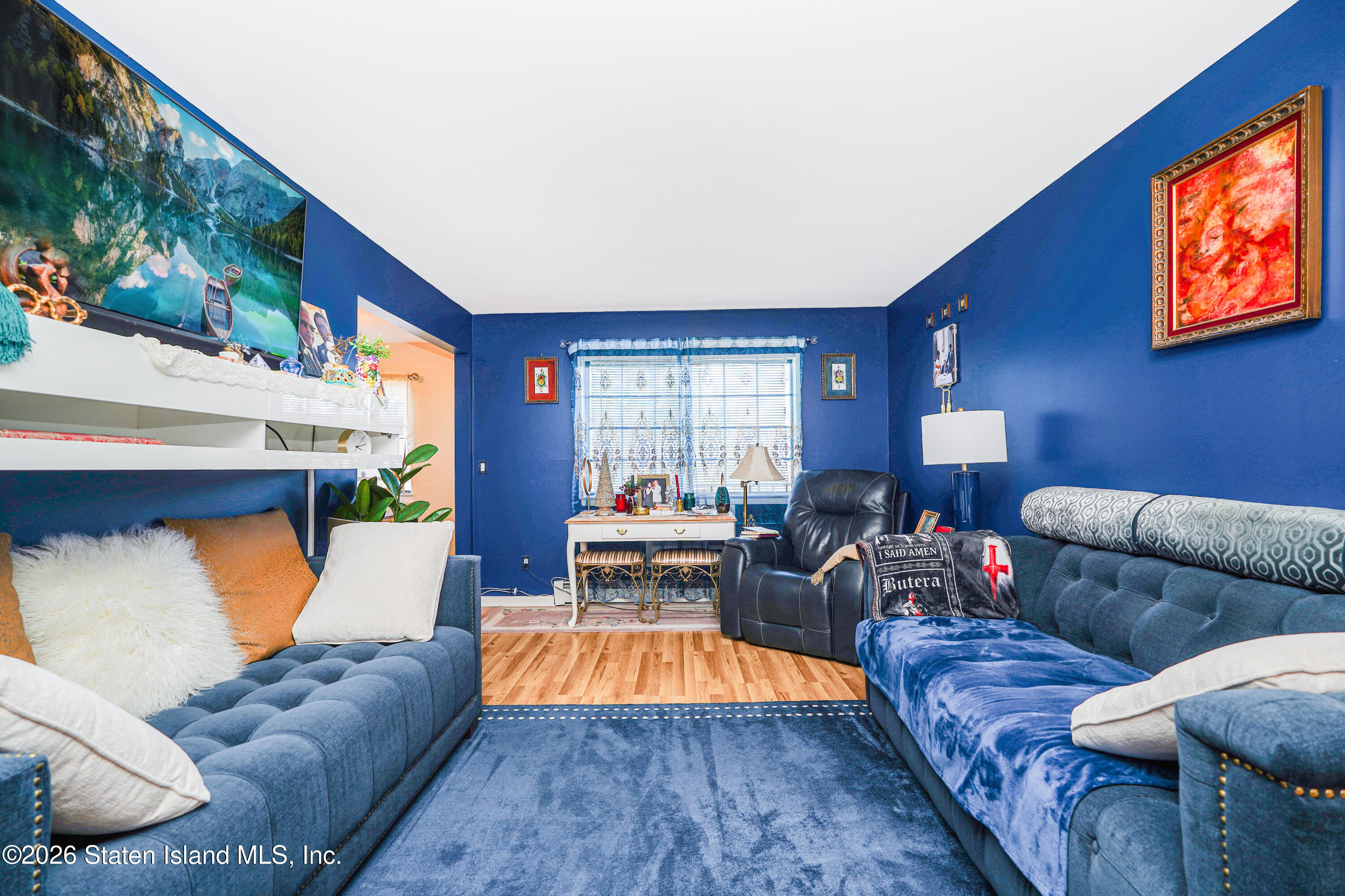120 Devon Loop, Unit 6 Staten Island, NY 10314 - Photo 3 of 19 a living room with furniture and a flat screen tv
