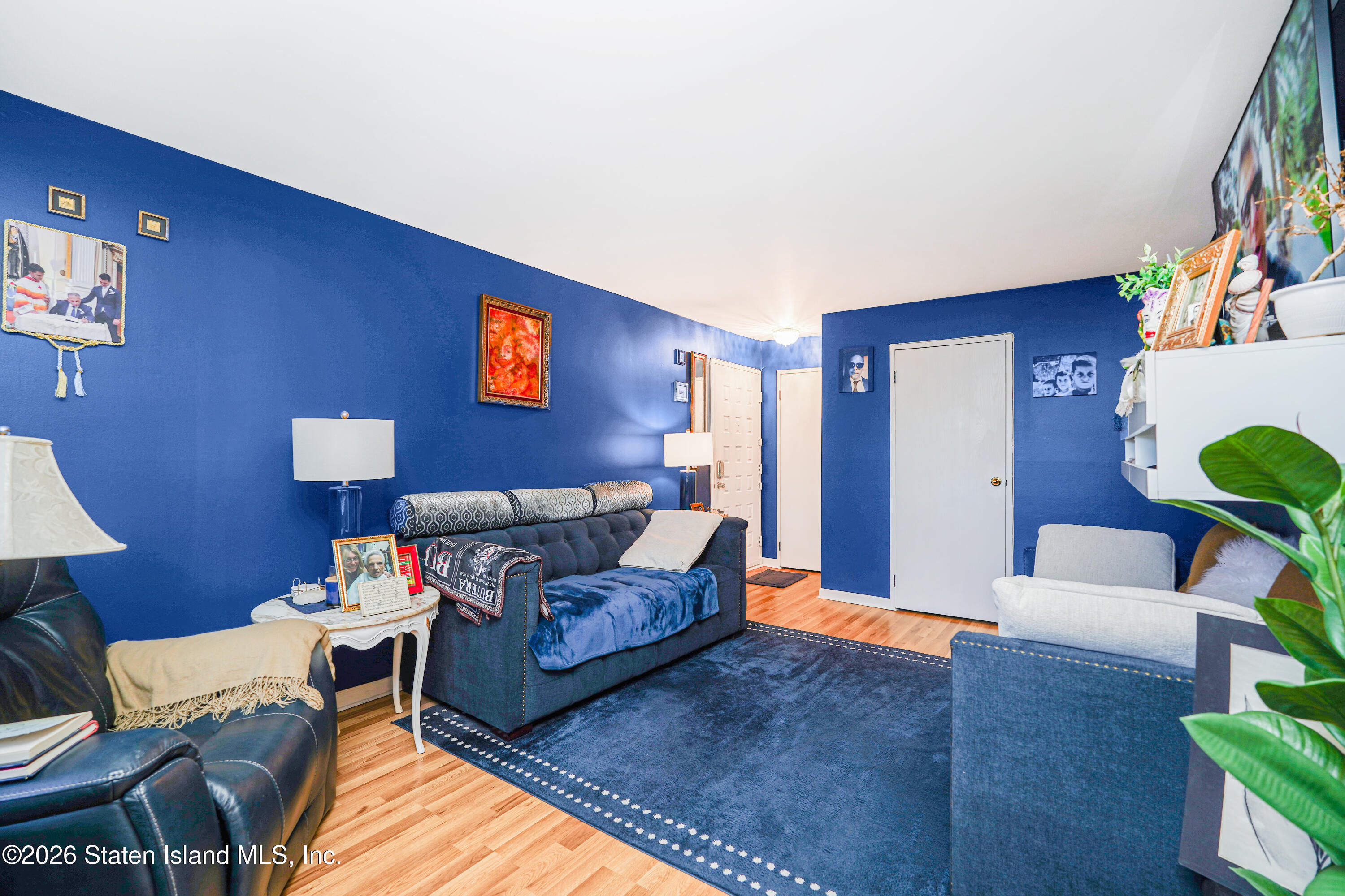 120 Devon Loop, Unit 6 Staten Island, NY 10314 - Photo 4 of 19 a living room with furniture and a lamp