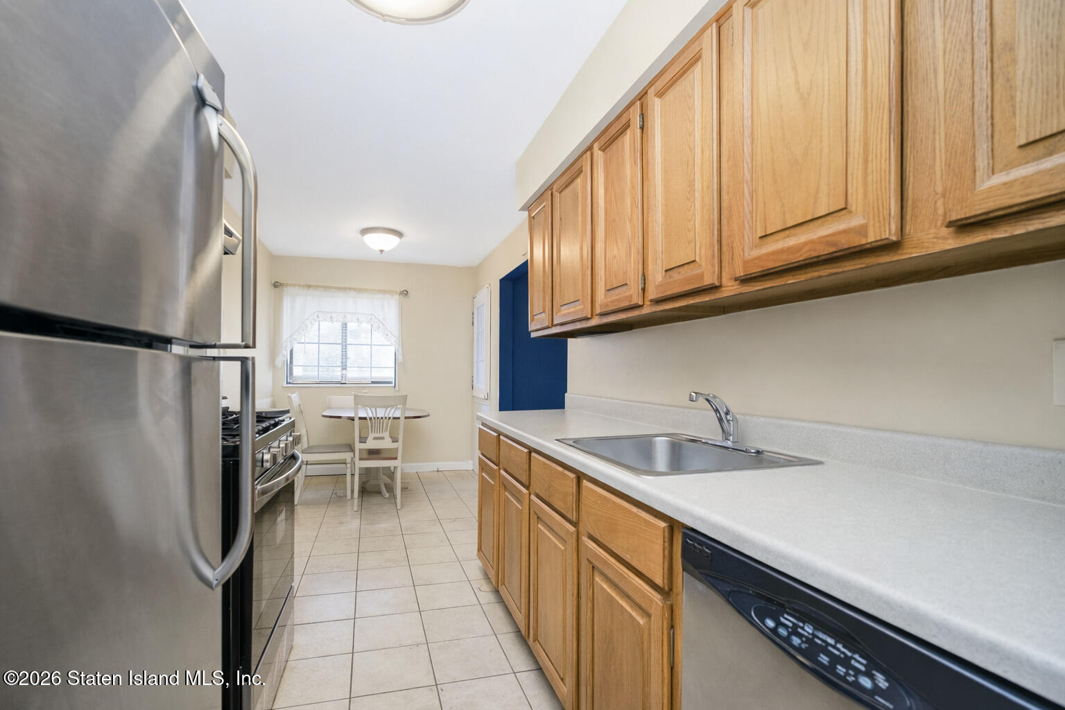 120 Devon Loop, Unit 6 Staten Island, NY 10314 - Photo 5 of 19 a kitchen with stainless steel appliances granite countertop a refrigerator sink and cabinets