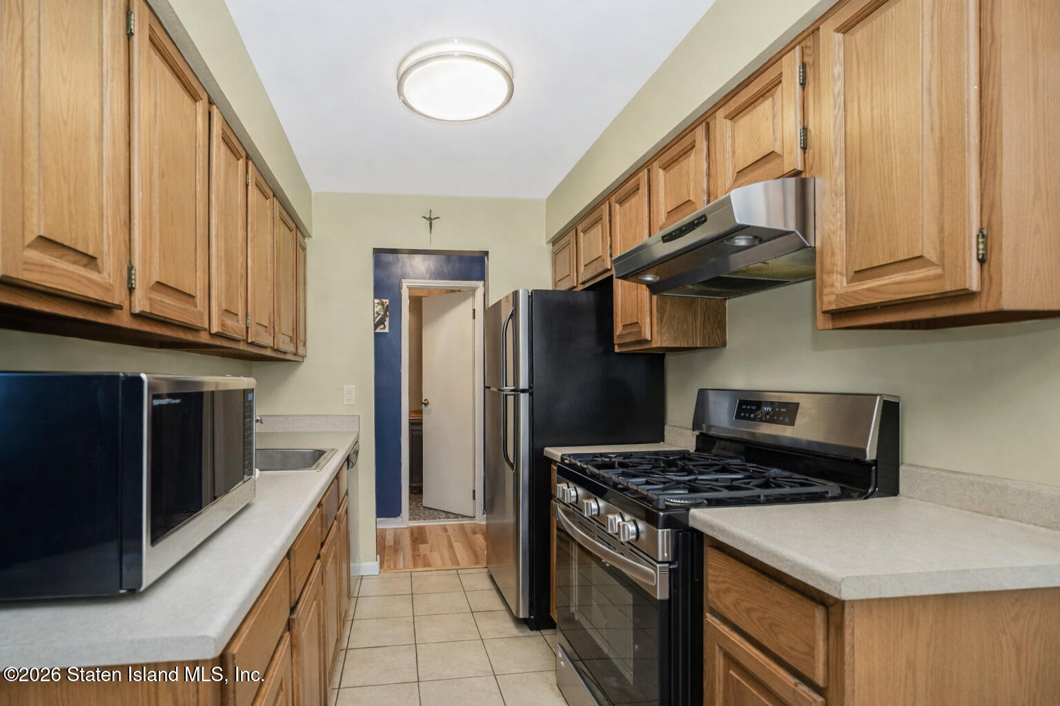 120 Devon Loop, Unit 6 Staten Island, NY 10314 - Photo 7 of 19 a kitchen with stainless steel appliances granite countertop a stove a refrigerator and a microwave
