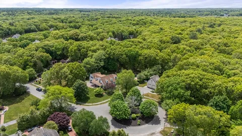 an aerial view of a house with a yard