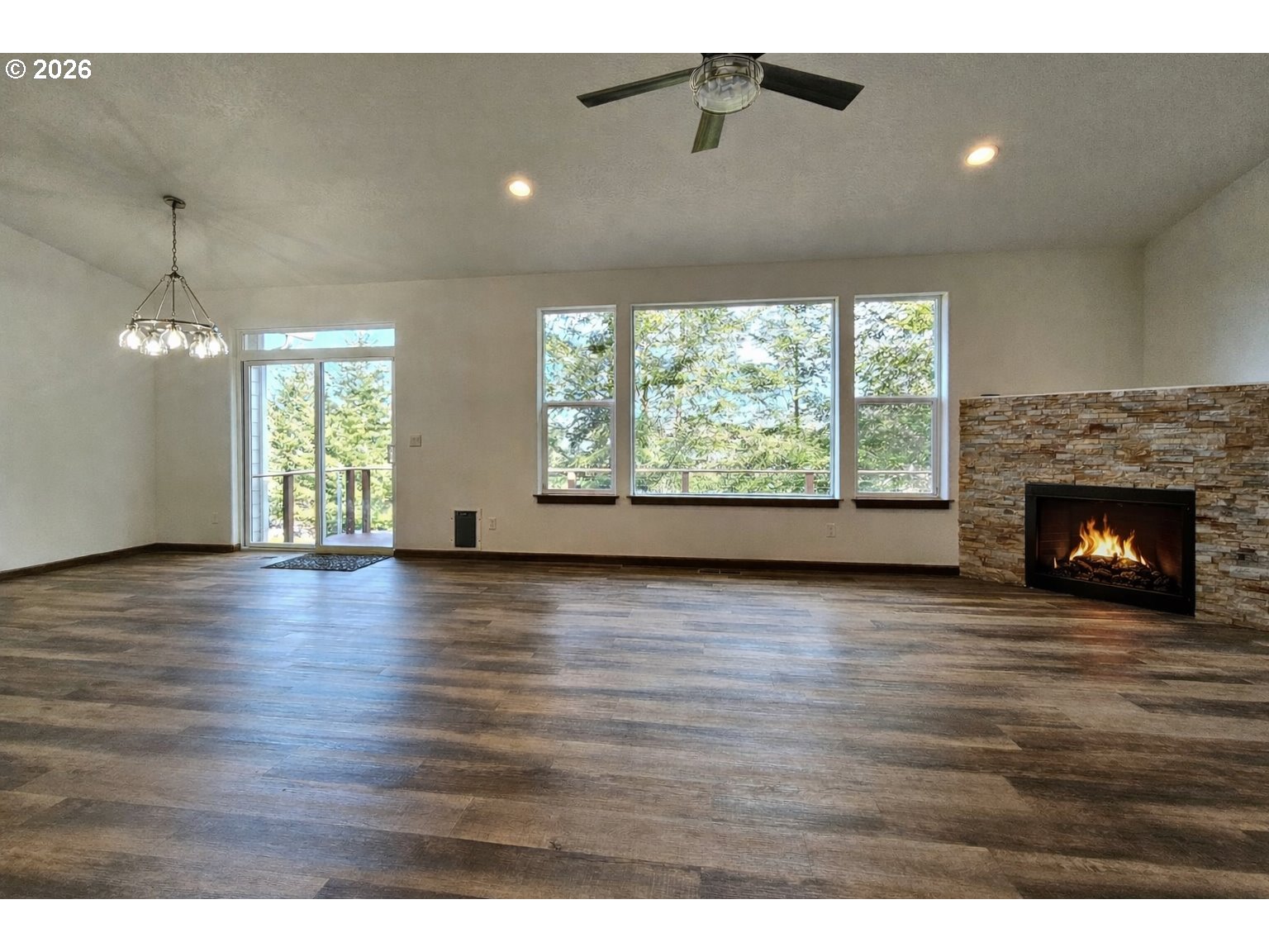 98205 Sunforest Court Brookings, OR 97415 - Photo 15 of 45 a view of an empty room with wooden floor and a window