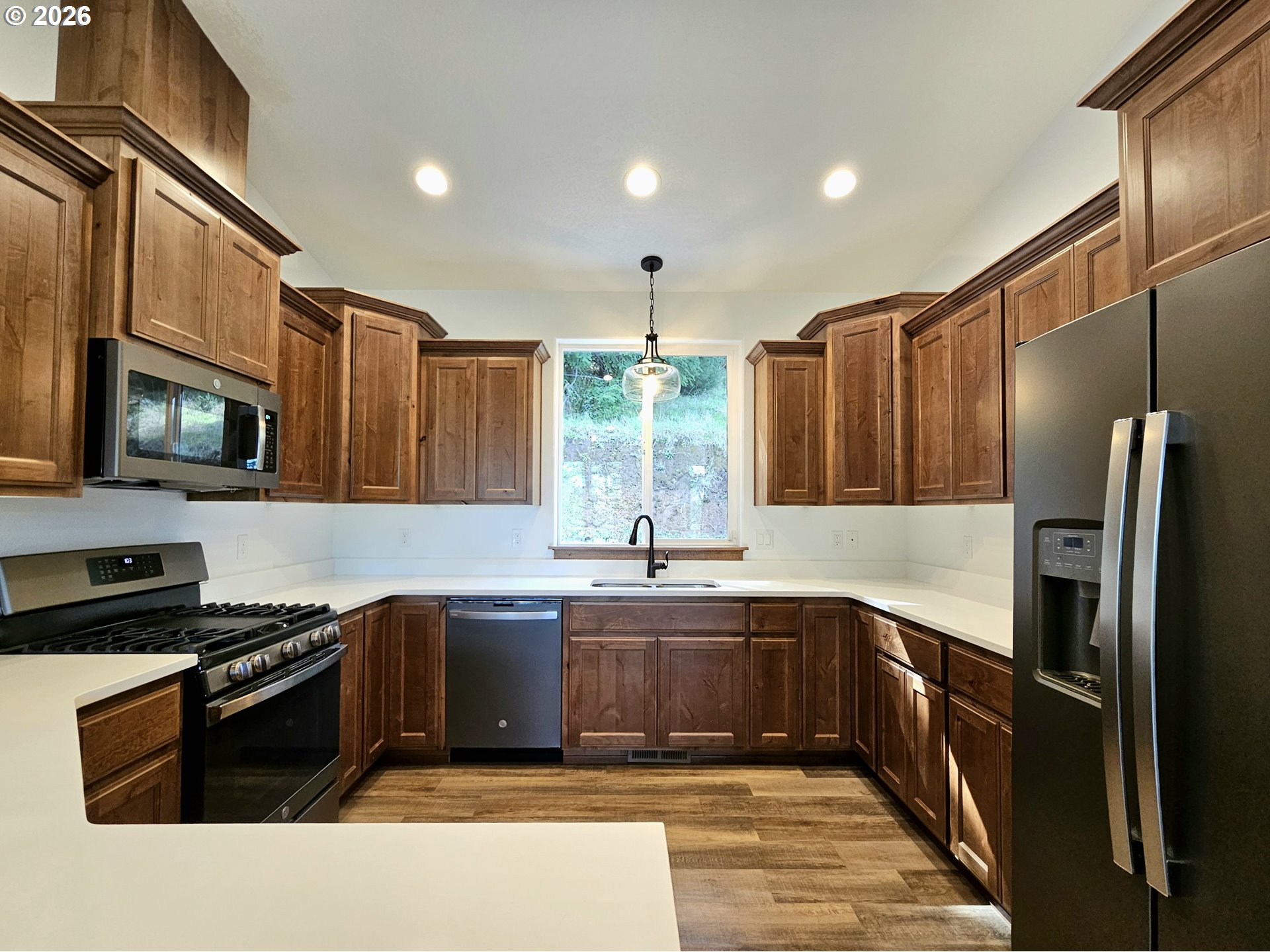 98205 Sunforest Court Brookings, OR 97415 - Photo 16 of 45 a kitchen with stainless steel appliances granite countertop a sink stove and refrigerator
