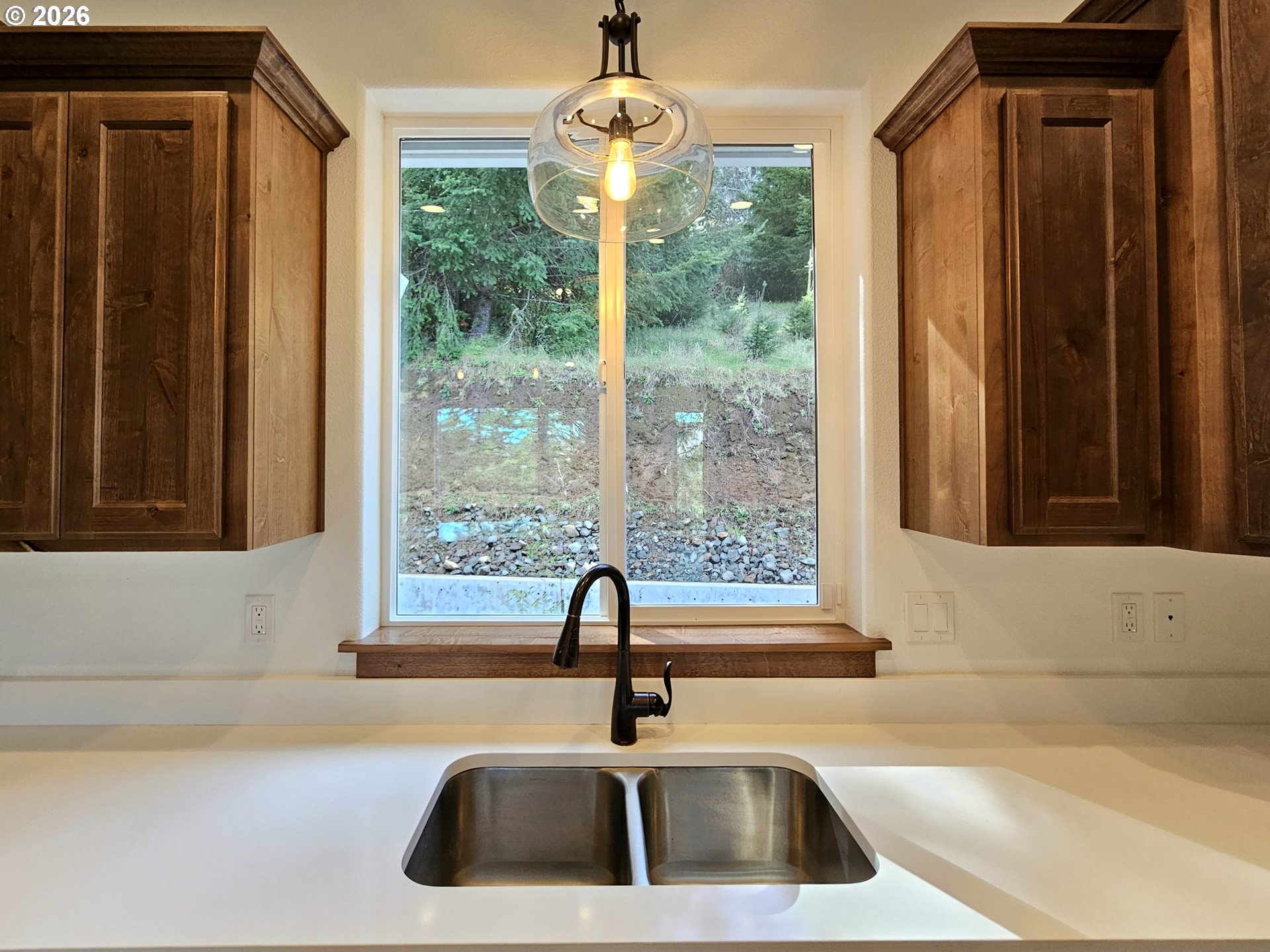 98205 Sunforest Court Brookings, OR 97415 - Photo 19 of 45 a bathroom with a sink a mirror and next to a window