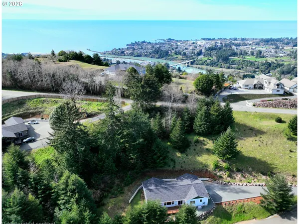 an aerial view of a houses with a lake view